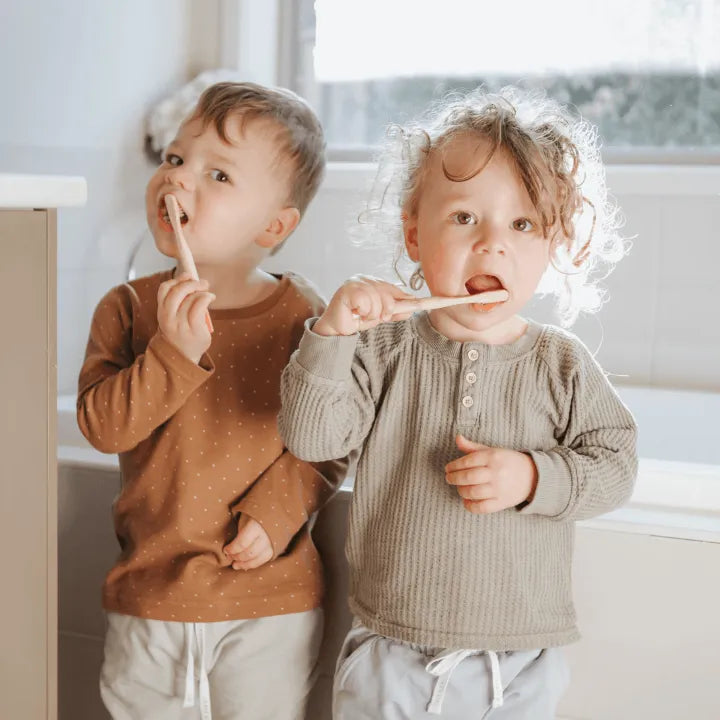 2 kids using the bamboo toothbrush | us and the earth