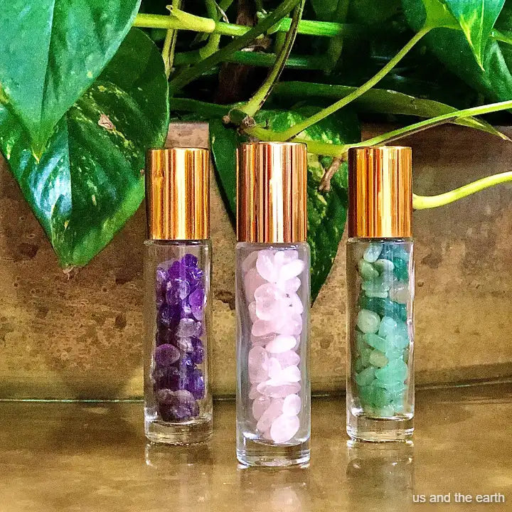 Three unique 10ml essential oil crystal gemstone roller bottles offered by 'Us and The Earth'.