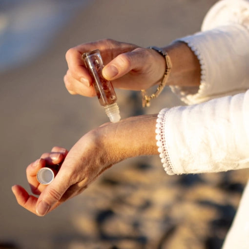 Applying Essential Oil Using Crystal Roller Bottles on Hands - Us and the Earth