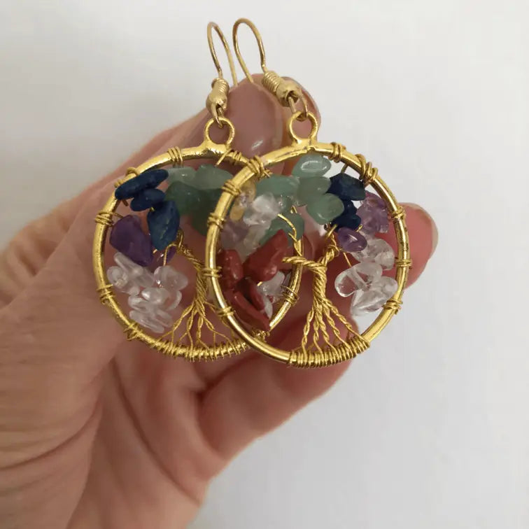 A pair of handmade crystal gemstone earrings with gold, featuring the symbolic 'Tree of Life' design.