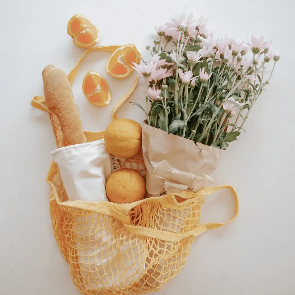 reusable cotton shopping net bag, fruits bread and flower in the mesh bag | us and the earth