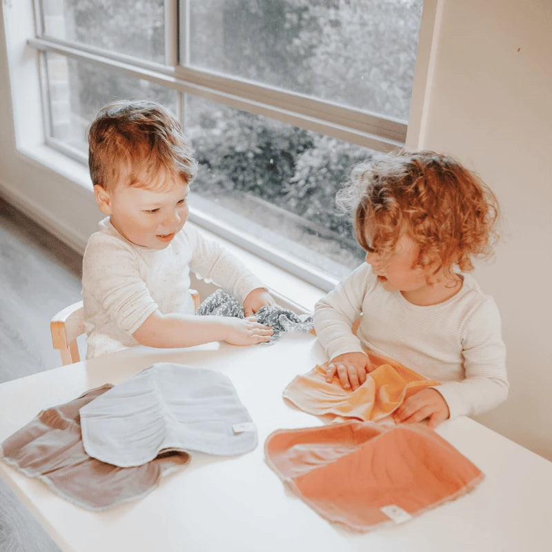 Two kids happily using reusable unpaper towels from Us and The Earth