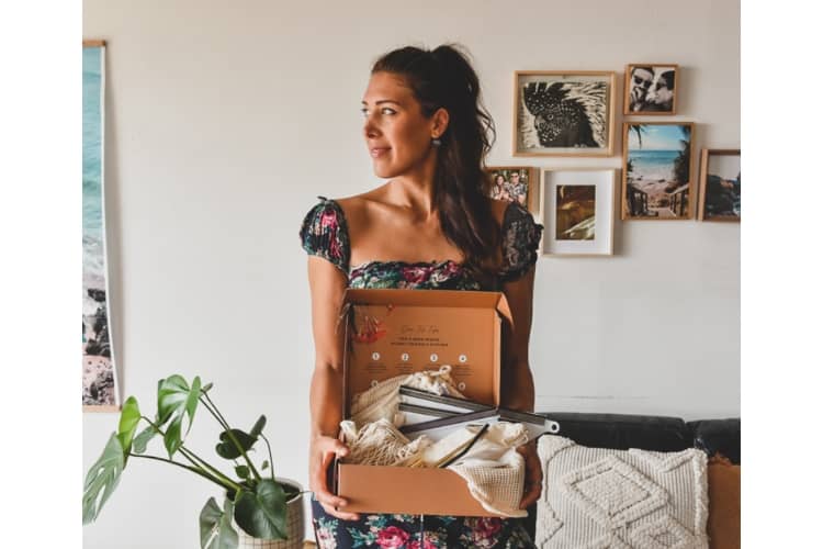 customer holding eco box products of us and the earth 